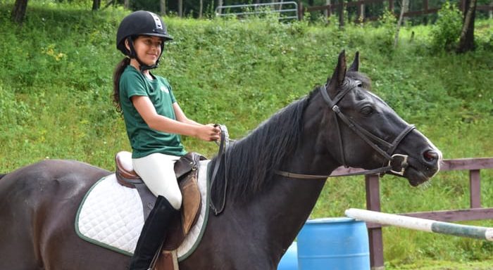 Camper horseback riding
