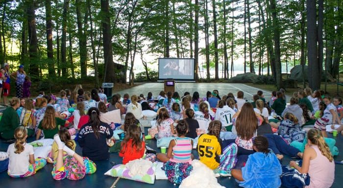 Campers watching an outdoor movie